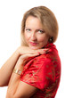 Blond woman in red dress with coquettish smile
