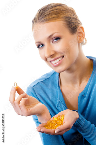 Photo: Woman with Omega 3 fish oil capsule, isolated on white Woman with Omega 3 fish oil capsule, isolated on white