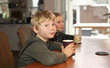 Photo: Boy and girl drinking at the table Boy and girl drinking at the table