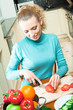 Portrait of happy smiling woman cooking with vegetables Portrait of happy smiling woman cooking with vegetables