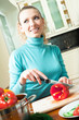 Portrait of happy smiling woman cooking with vegetables Portrait of happy smiling woman cooking with vegetables