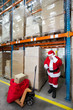 Santa claus checking list of presents in storehouse