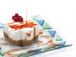 pouring cranberry sauce on a cheese cake