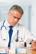 Doctor examining medicine cases