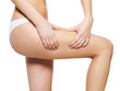 Woman squeezes cellulite skin on her legs