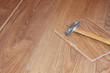 hammer and laminate plank on floor