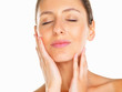 Pretty woman with hands on face and eyes closed