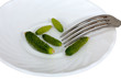 Very small cucumbers on a saucer with plug
