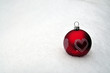 Red bauble on snow