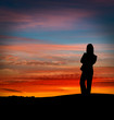 Silhouette of woman at sunset