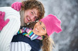 young playful couple has a fun winter time in a snow park