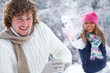 Couple playing snowballs