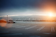 Empty parking lot space under dramatic sunset sky Empty parking lot space under dramatic sunset sky