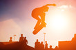 Photo: Skateboarder jump over sunny sunset sky Skateboarder jump over sunny sunset sky