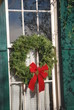 Christmas wreath on window of historic house