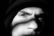 Young man with beanie in shadows