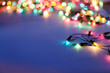 Christmas lights on dark blue background with copy space. Decora