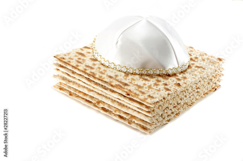 Photo: Jewish Passover holiday still life with matzoh and kippah on whi Jewish Passover holiday still life with matzoh and kippah on whi