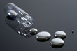 Mercury and glass container on a reflective surface.