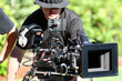 Foto: Man with digital cinema camera on movie set Man with digital cinema camera on movie set