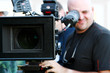 Foto: Man with digital cinema camera on movie set Man with digital cinema camera on movie set