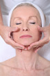 Closeup of senior woman having a face massage Closeup of senior woman having a face massage