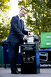 A businessman recycling household batteries