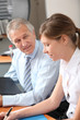 Senior businessman with young woman in the office