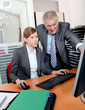 Senior businessman with young woman in the office