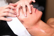 Close up portrait of a young woman with eyes closed receiving fa