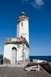 The lighthouse at the port of Praia, and old cannon looking to t The lighthouse at the port of Praia, and old cannon looking to t
