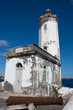 The lighthouse at the port of Praia, and old cannon looking to t The lighthouse at the port of Praia, and old cannon looking to t