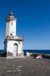 The lighthouse at the port of Praia, and old cannon looking to t The lighthouse at the port of Praia, and old cannon looking to t