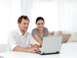 Photo: Happy man and woman looking at something on the laptop Happy man and woman looking at something on the laptop