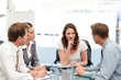 Charismatic businesswoman at a table with her team