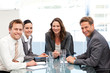 Portrait of a businesswoman with her team sitting at a table