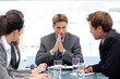 Serious manager talking to his team during a meeting