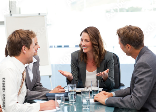 Photo: Attractive businesswoman laughing with her team Attractive businesswoman laughing with her team