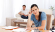 Worried woman doing her account while her boyfriend waiting in t