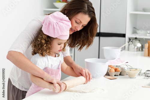 Photo: Mother and daughter using a rolling pin together Mother and daughter using a rolling pin together
