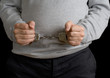 Photo: Man in handcuffs on black background Man in handcuffs on black background