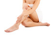 Photo: Slim woman sitting on white background Slim woman sitting on white background