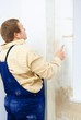 Man painting wall with roller Man painting wall with roller