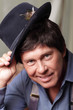 Man smiling and tipping his hat