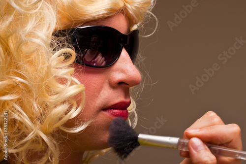 Photo: Make up artist working on a model Make up artist working on a model