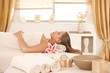 Young woman resting on massage bed at spa.