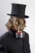 Foto: Businessman wearing a gas mask and a top hat Businessman wearing a gas mask and a top hat