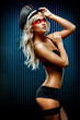 Foto: Young sexy woman in front of wall of blue stripes Young sexy woman in front of wall of blue stripes