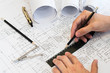 Design drawings and human hands drawing a project Design drawings and human hands drawing a project