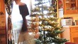 Young man sets up the Christmas tree in his living room
